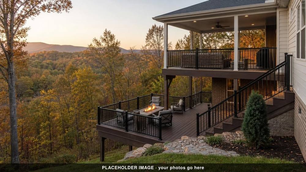Multi-level deck with fire table and black railings below a covered porch, autumn hills at dusk (placeholder image)