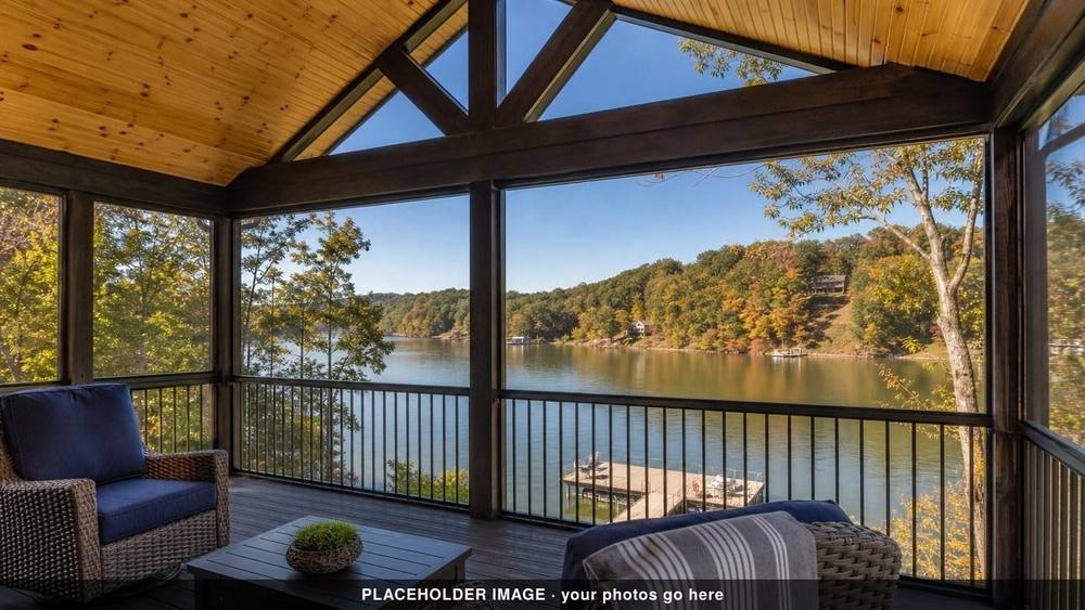Screened porch with vaulted wood ceiling and wicker chairs over a lake in autumn (placeholder image)