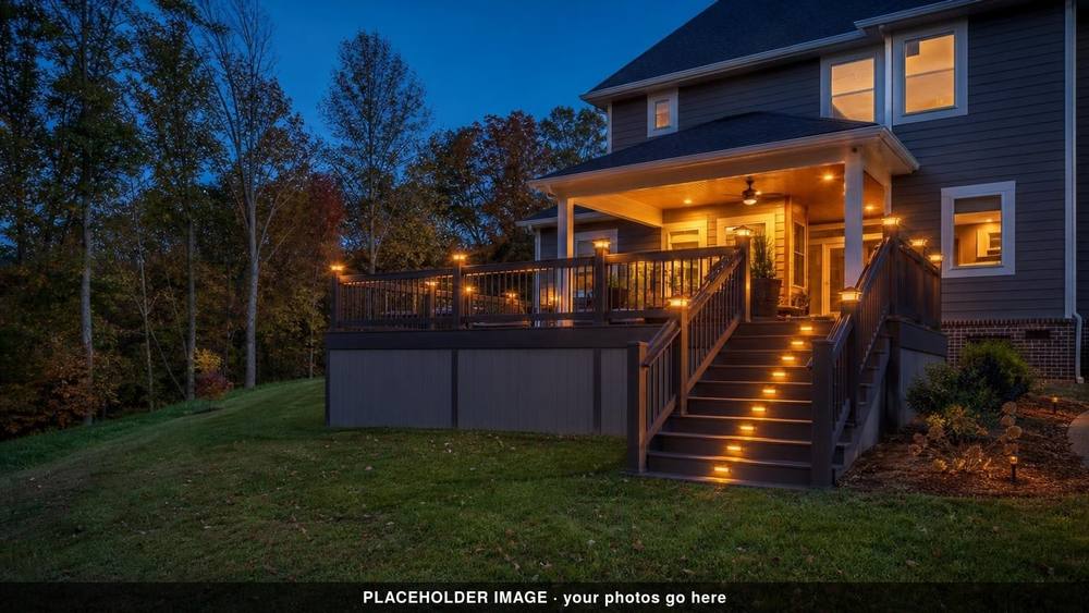 Deck stairs and post caps lit at dusk beside a covered porch (placeholder image)